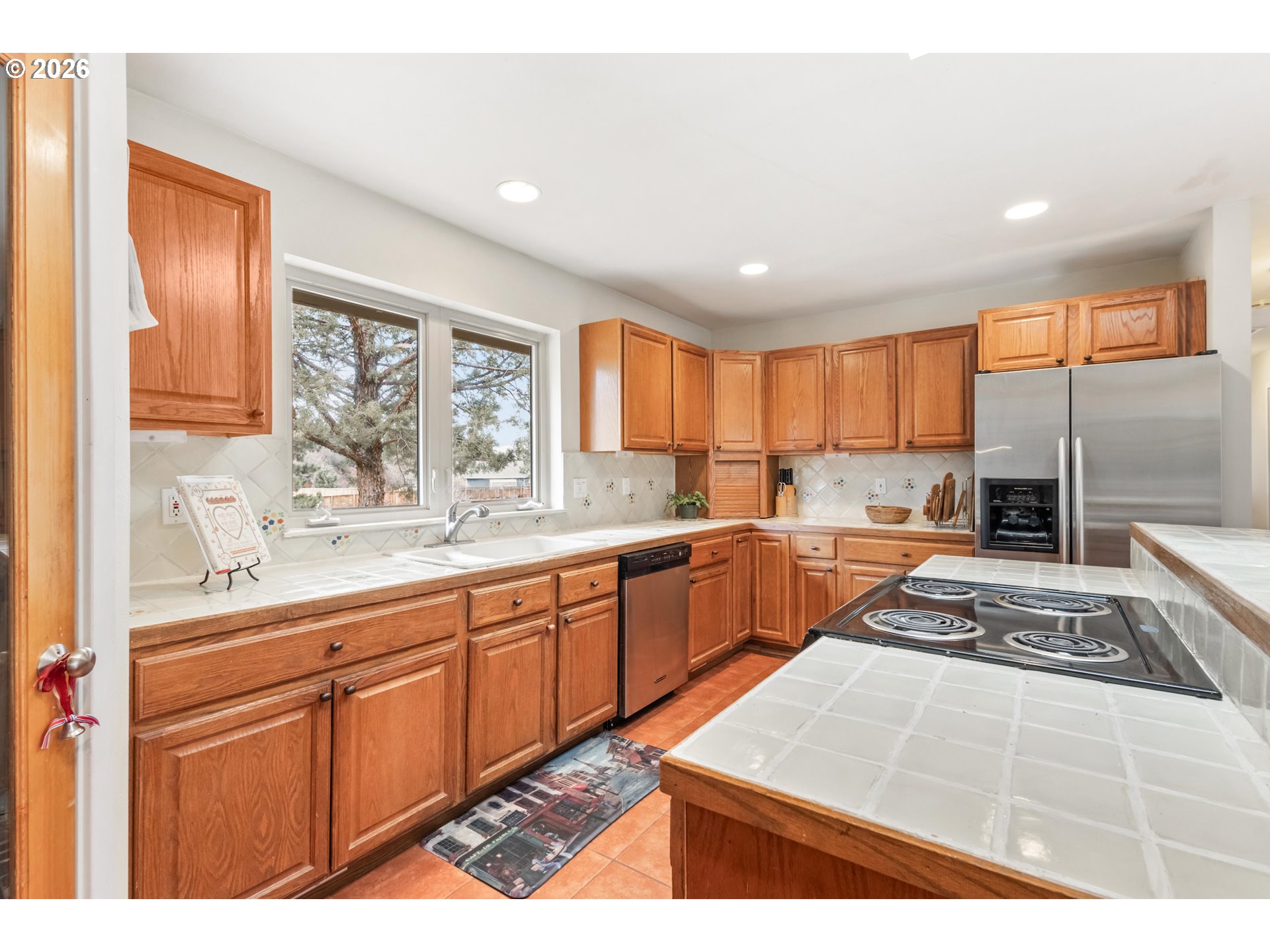 61082 Ferguson Court Bend, OR 97702 - Photo 10 of 48 a kitchen with stainless steel appliances granite countertop a sink stove and refrigerator