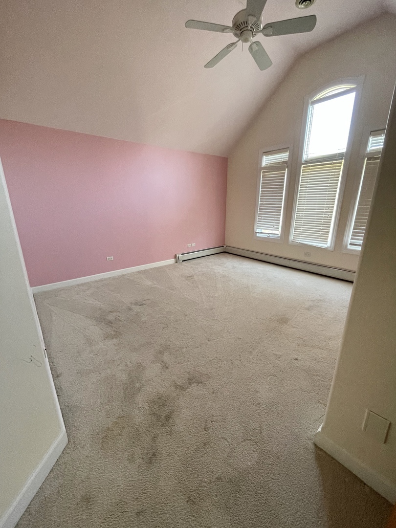 990 Stonehedge Drive Addison, IL 60101 - Photo 13 of 18 an empty room with a ceiling fan and window