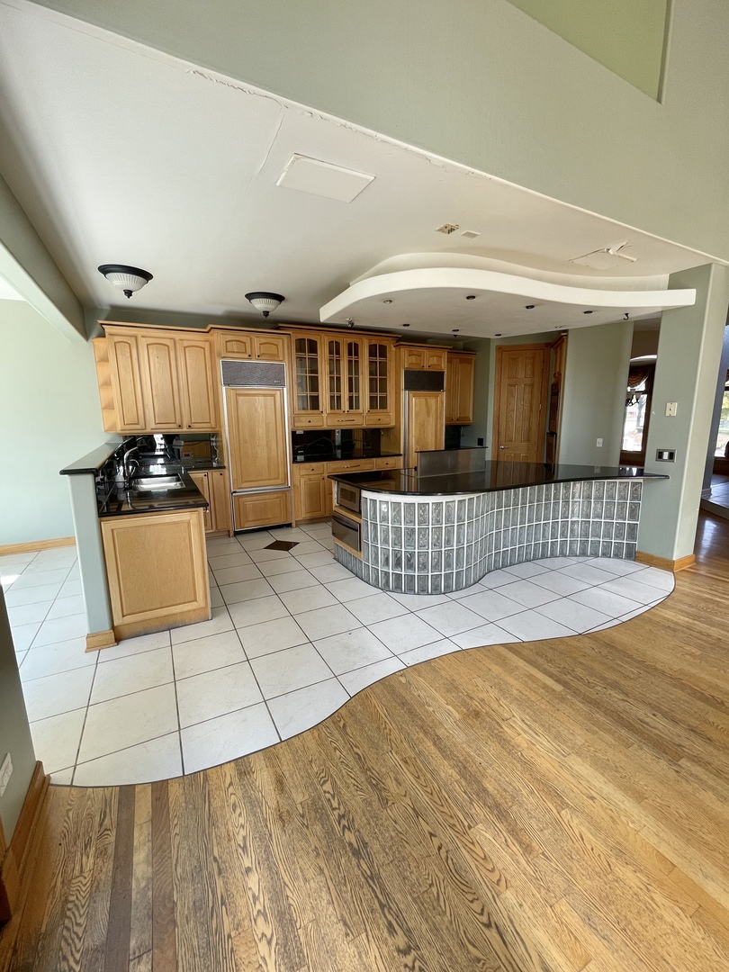 990 Stonehedge Drive Addison, IL 60101 - Photo 7 of 18 a view of a house with a barbeque and wooden stairs