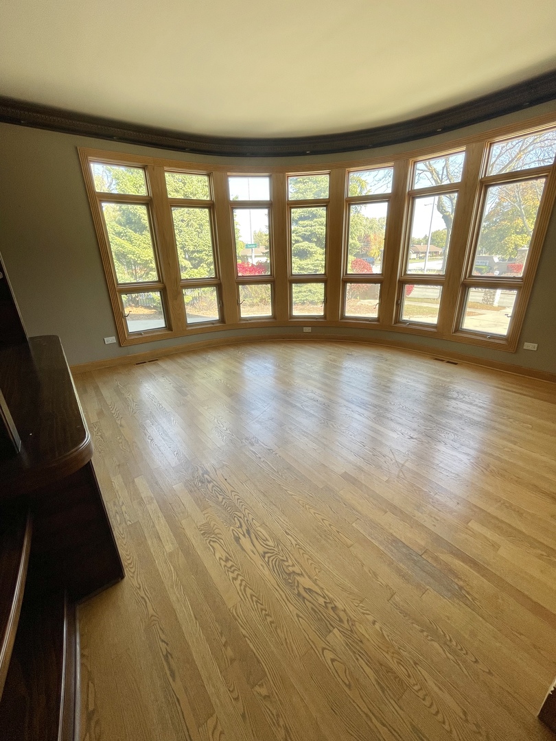 990 Stonehedge Drive Addison, IL 60101 - Photo 9 of 18 wooden floor in an empty room with a window