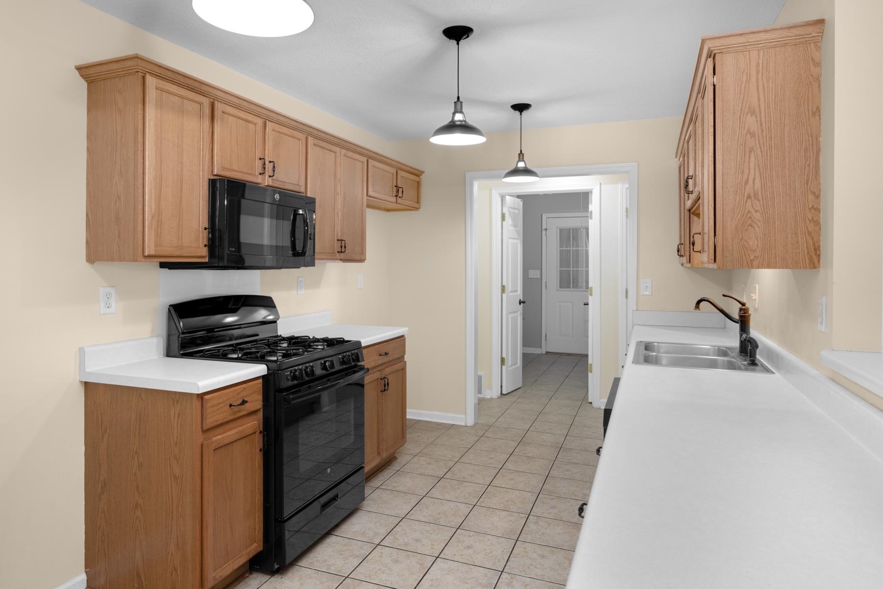 1876 Durhamville Road Ripley, TN 38063 - Photo 33 of 37 a kitchen with stainless steel appliances granite countertop a stove and a sink
