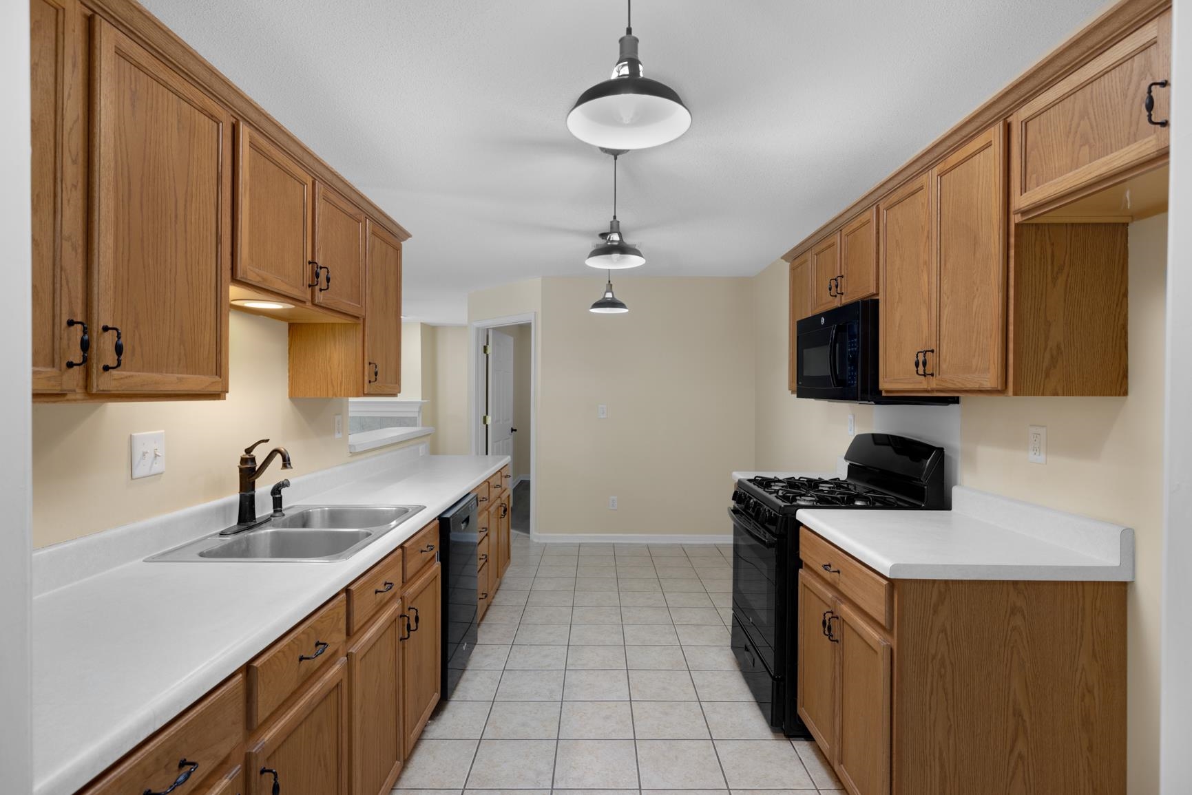 1876 Durhamville Road Ripley, TN 38063 - Photo 34 of 37 a kitchen with a sink a stove and cabinets