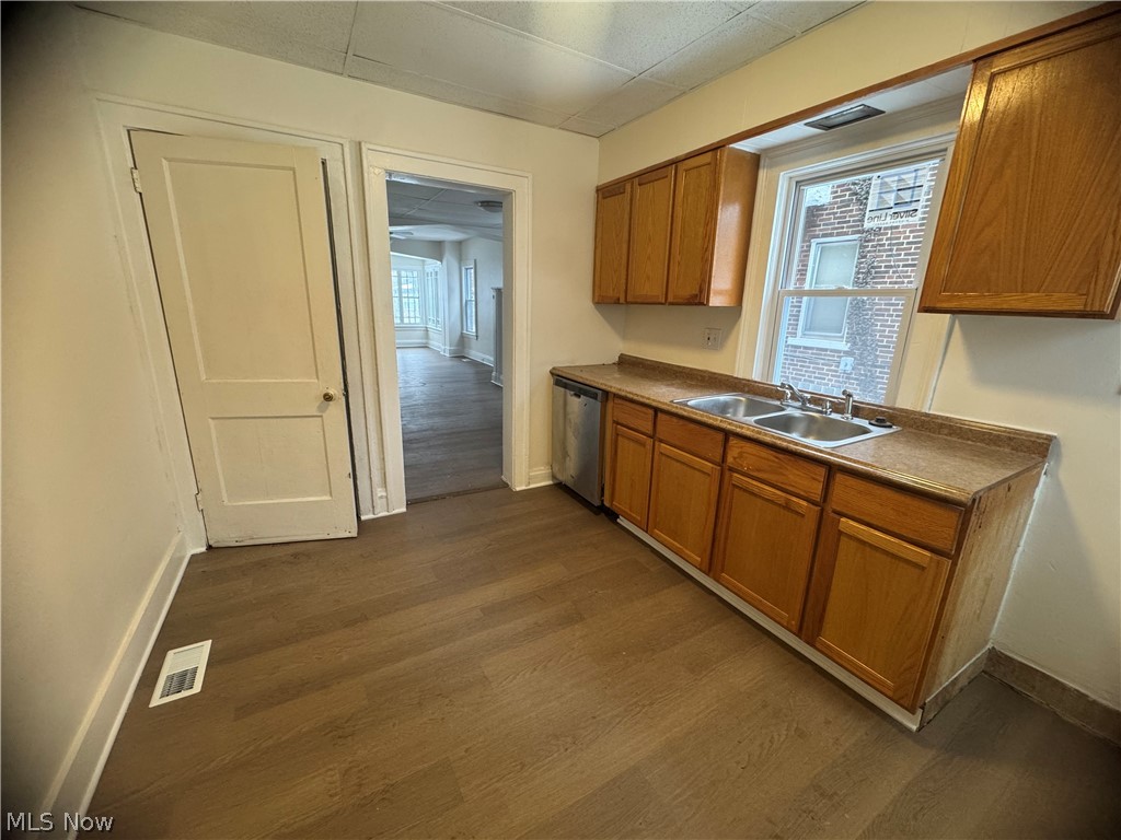 3242 Sycamore Road, Unit LEFT SIDE Cleveland Heights, OH 44118 - Photo 8 of 20 Kitchen with wood finish cabinetry, dark wood finished floors, and stainless steel dishwasher