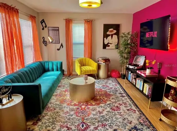 a living room with furniture and a flat screen tv
