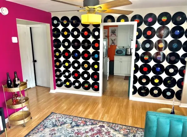 a view of walk in closet and wooden floor