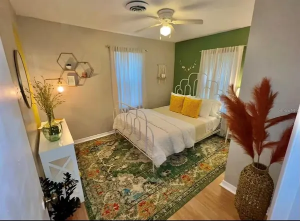 a bedroom with a bed and a chandelier