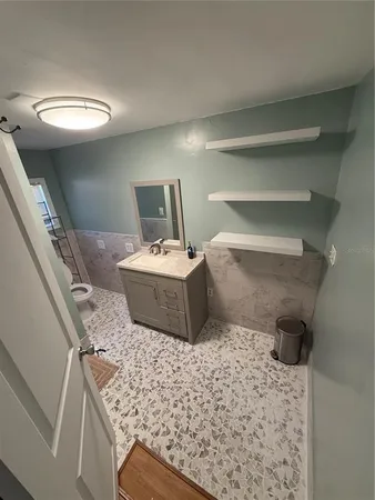 a bedroom with a bed and a large mirror