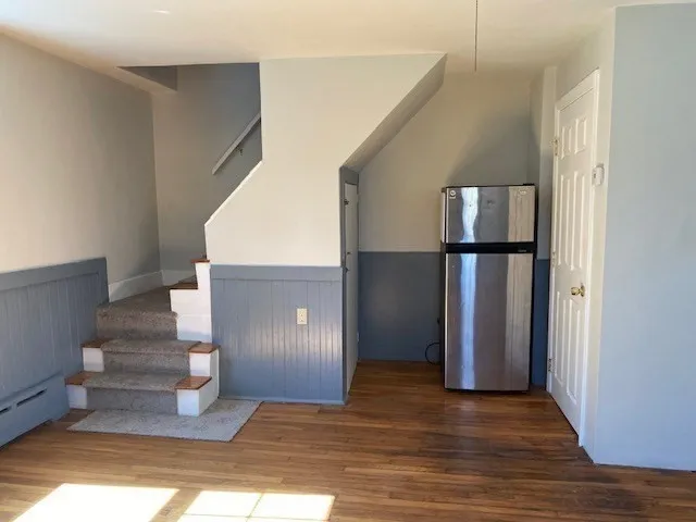 a view of entryway and hall with wooden floor