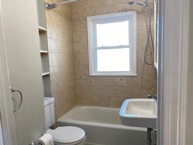 a bathroom with a toilet sink and bathtub