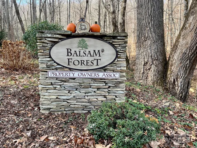 a view of a sign of a building with large trees