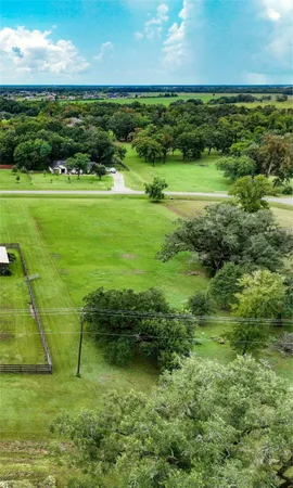 a view of a golf course with a large trees