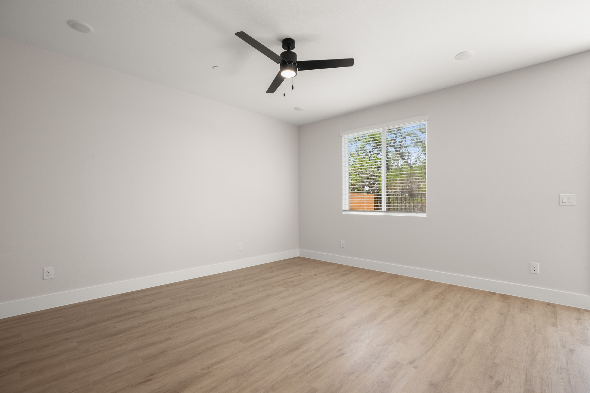 5502 Mobeetie Loop Bee Cave, TX 78738 - Photo 5 of 16 Spacious room featuring light wood-finish flooring, white baseboards, and neutral wall tones