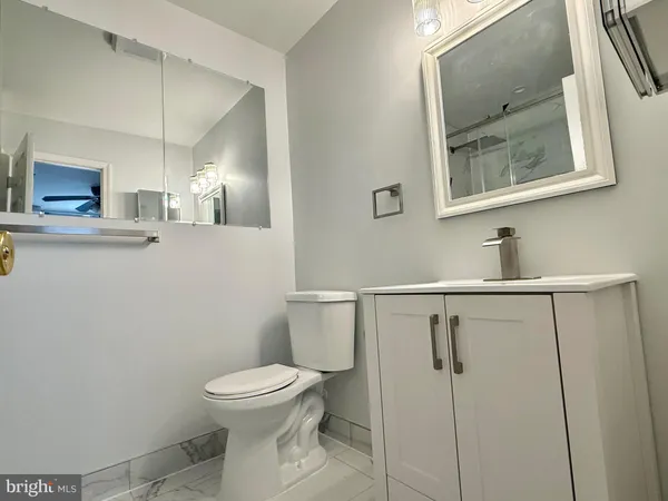 a bathroom with a toilet sink and mirror