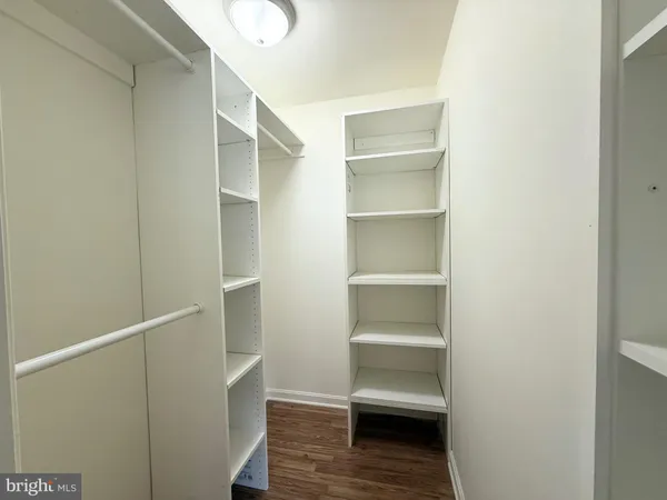 a view of walk in closet with empty racks