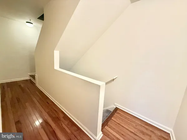 a view of hallway with wooden floor