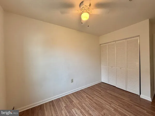 a view of a room with wooden floor and natural light