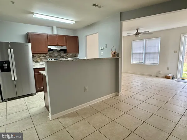 a kitchen with stainless steel appliances a refrigerator sink and cabinets
