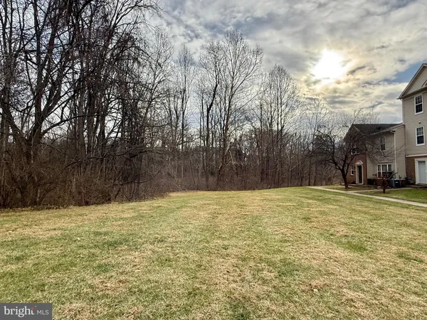 a swimming pool with trees in the background