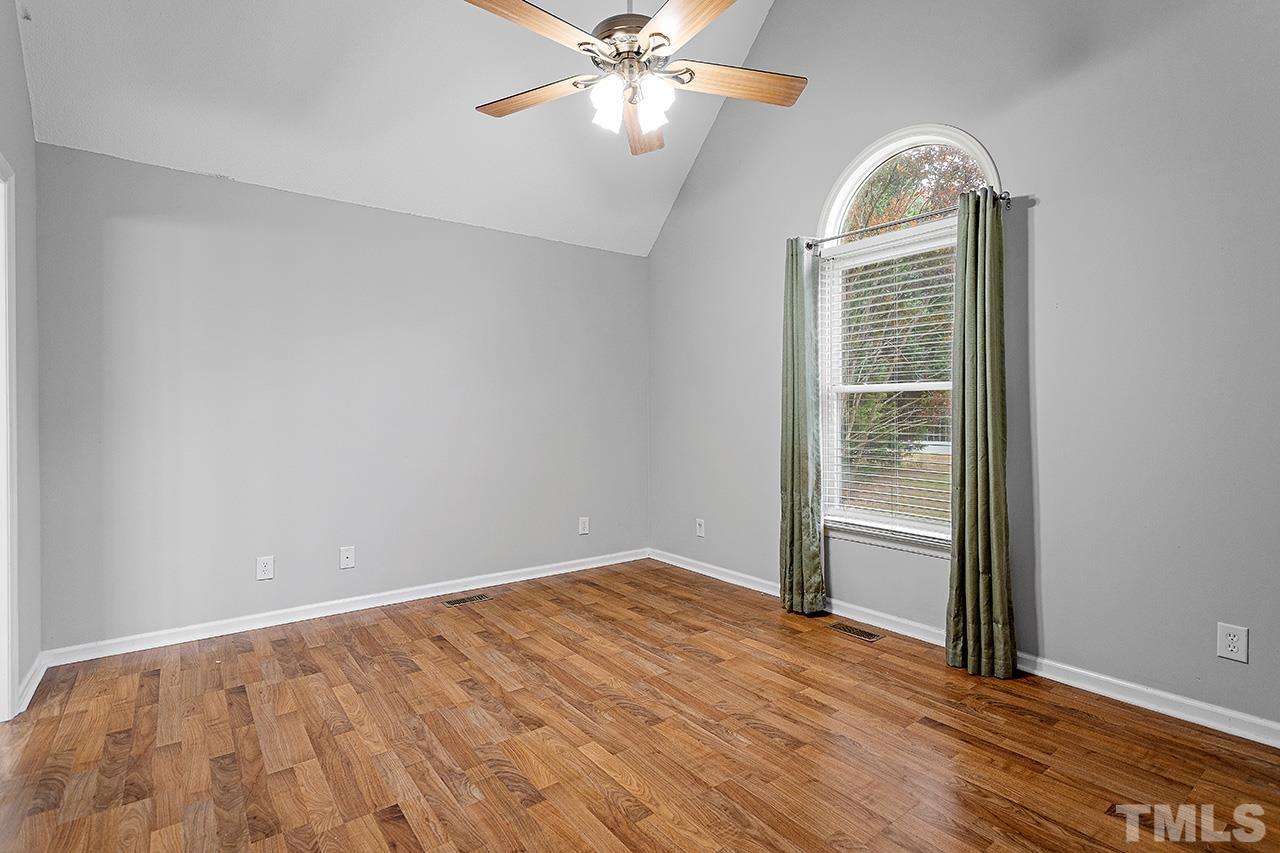 53 Phil Johnson Road Sanford, NC 27330 - Photo 14 of 29 an empty room with windows and ceiling fan