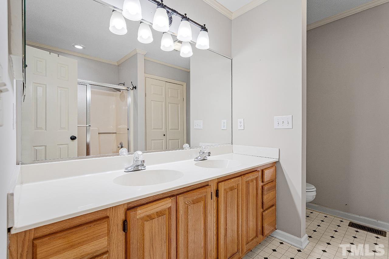 53 Phil Johnson Road Sanford, NC 27330 - Photo 15 of 29 a bathroom with a sink a vanity and a mirror