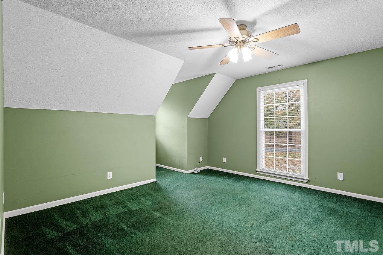 53 Phil Johnson Road Sanford, NC 27330 - Photo 20 of 29 a view of an empty room with window and chandelier fan