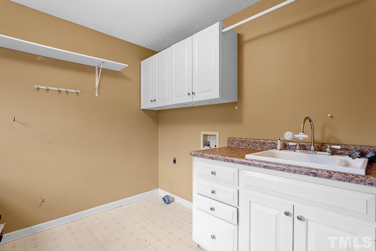 53 Phil Johnson Road Sanford, NC 27330 - Photo 22 of 29 a room with a sink and cabinets