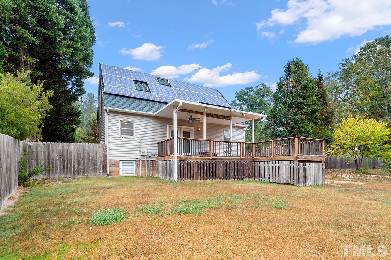 53 Phil Johnson Road Sanford, NC 27330 - Photo 23 of 29 a view of a backyard with a large tree and wooden fence