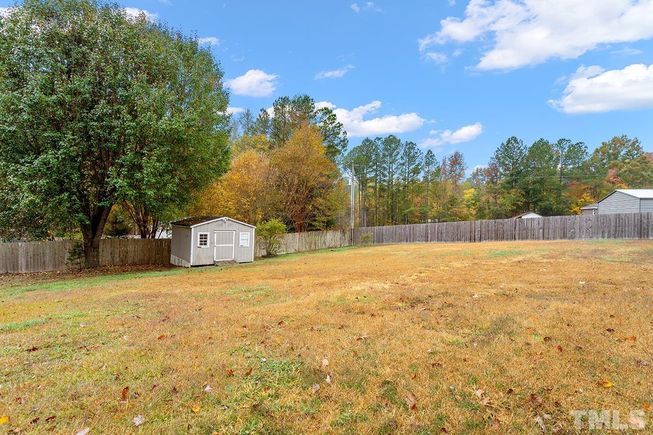 53 Phil Johnson Road Sanford, NC 27330 - Photo 26 of 29 a view of an house with swimming pool and trees in the background
