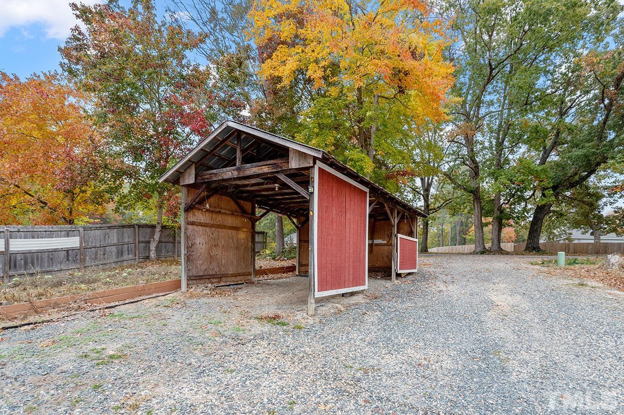 53 Phil Johnson Road Sanford, NC 27330 - Photo 29 of 29 a view of a wooden house with a large tree
