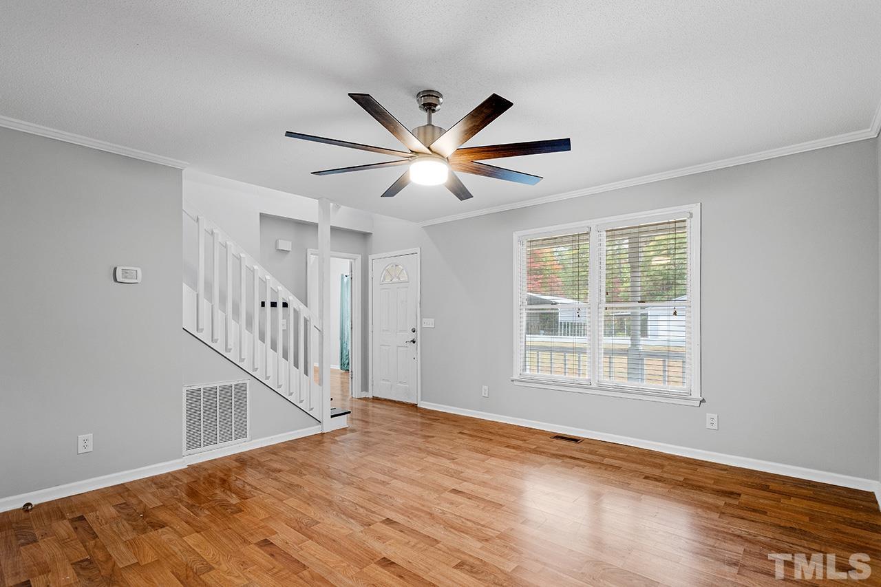 53 Phil Johnson Road Sanford, NC 27330 - Photo 4 of 29 a view of an empty room with wooden floor and a window