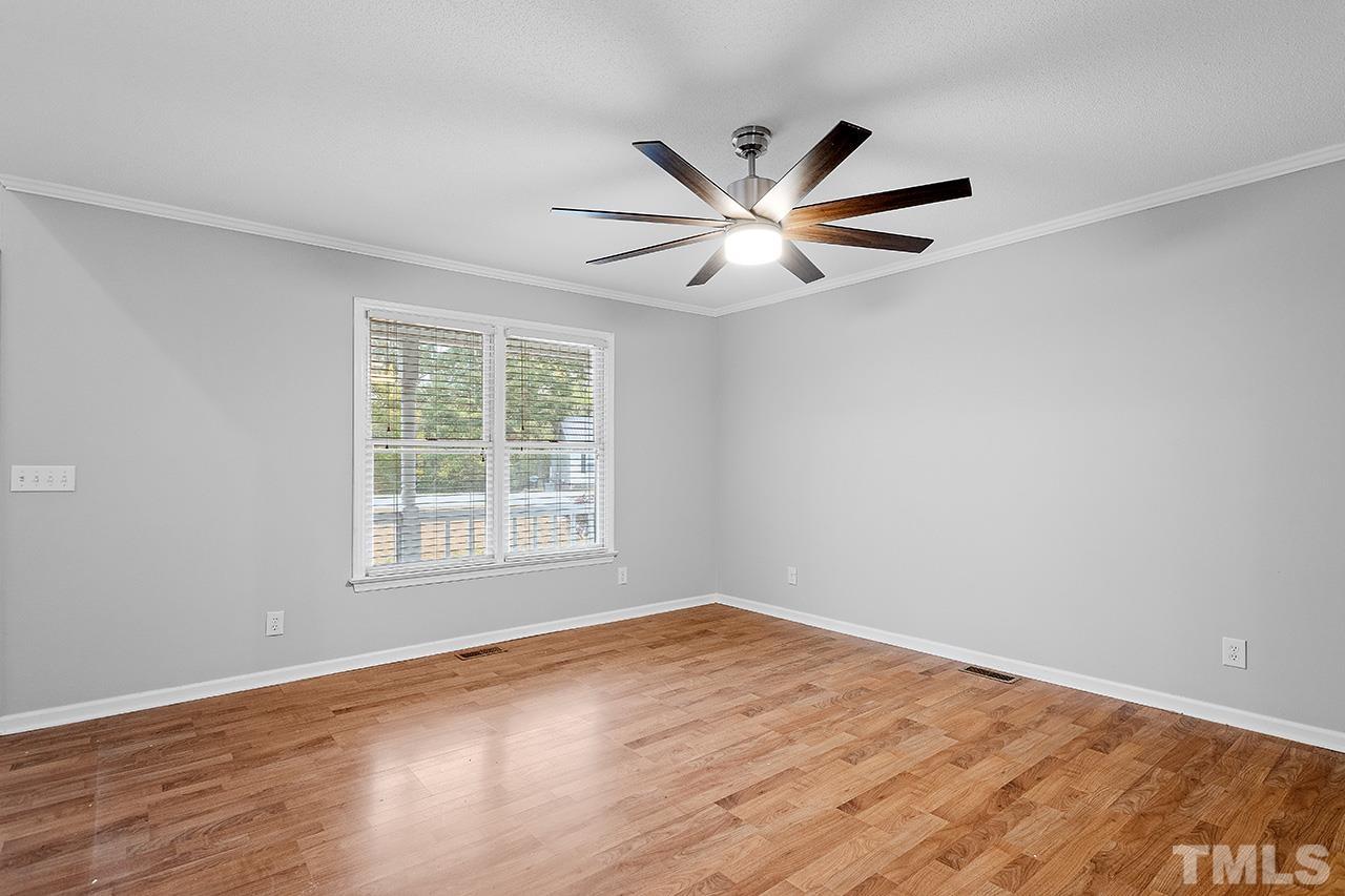 53 Phil Johnson Road Sanford, NC 27330 - Photo 7 of 29 a view of an empty room with wooden floor and a window