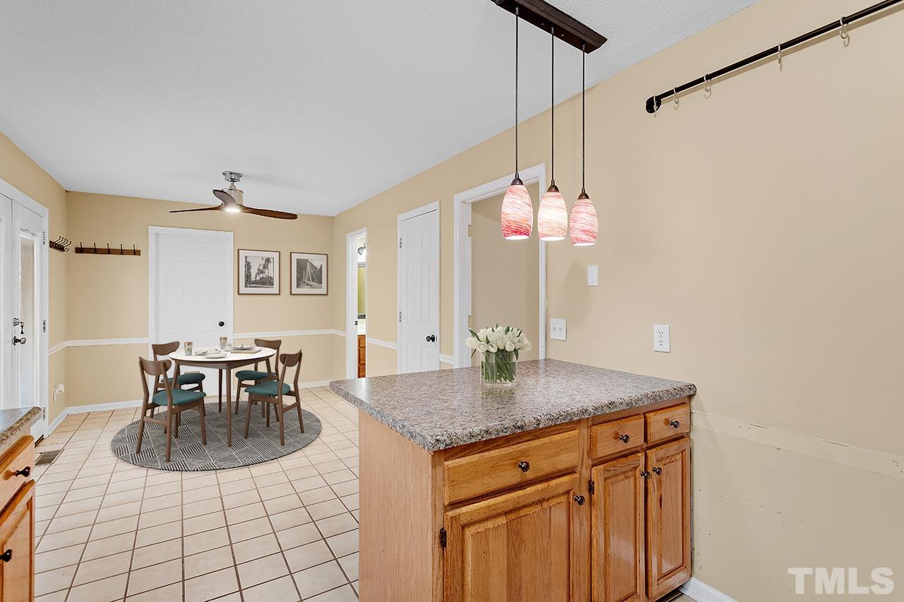 53 Phil Johnson Road Sanford, NC 27330 - Photo 10 of 29 a kitchen with a dining table and chairs