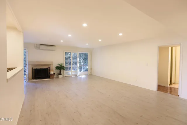 a view of a livingroom with an empty space and a fireplace