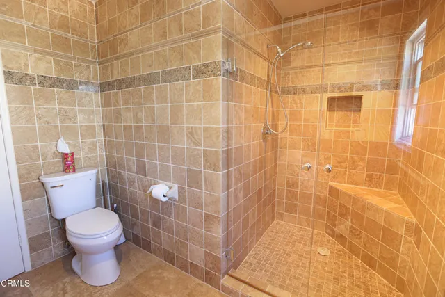 a bathroom with a toilet and a shower