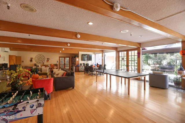 a living room with lots of furniture and wooden floor