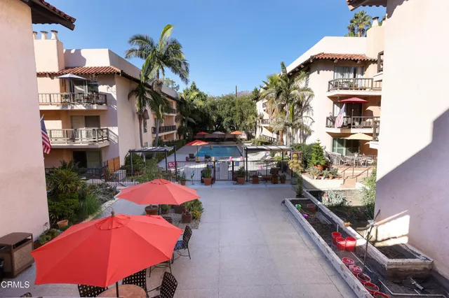 a view of a patio with couches table and chairs and potted plants