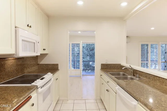 a kitchen that has a sink and a stove