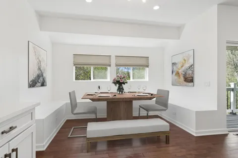 a large kitchen with cabinets wooden floor and a refrigerator