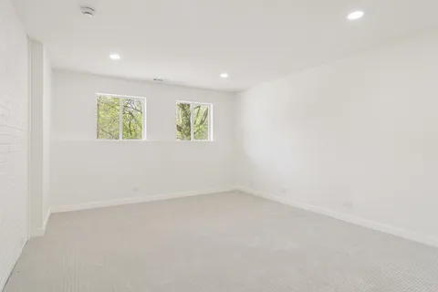 a balcony with wooden floor in front of it