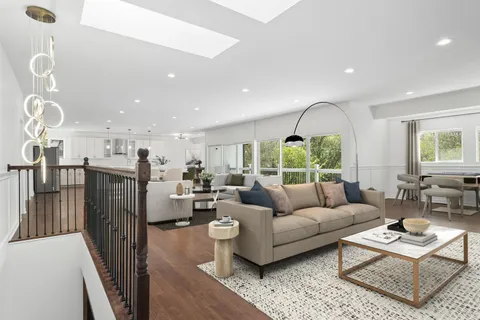 a view of a livingroom with wooden floor and windows
