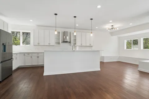 a kitchen with a sink stove and cabinets