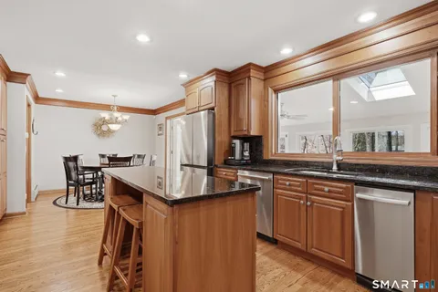 a kitchen with lots of counter top space and painting on the wall