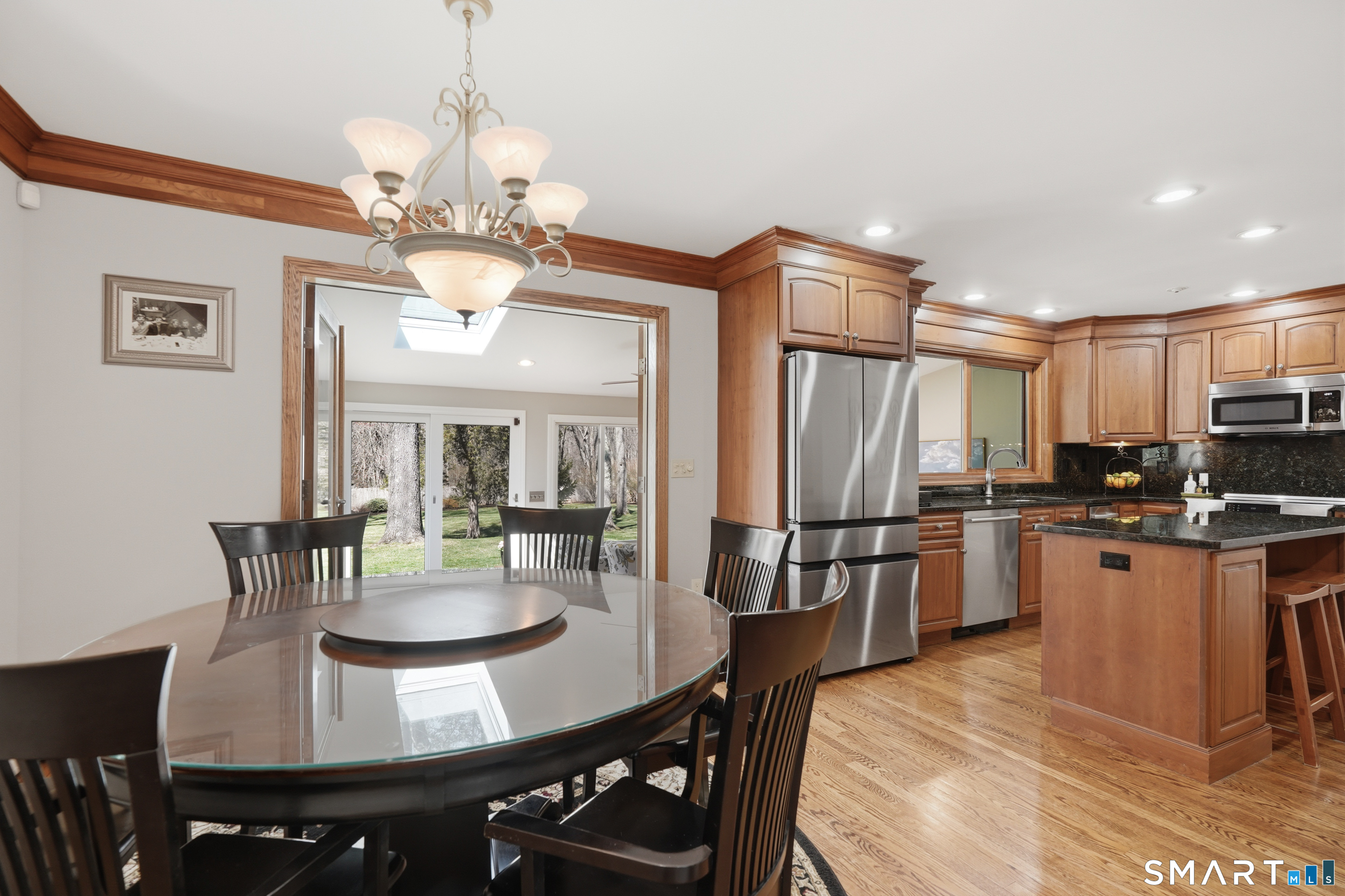 21 Shawnee Lane Monroe, CT 06468 - Photo 13 of 39 a view of a dining room with furniture a chandelier and wooden floor