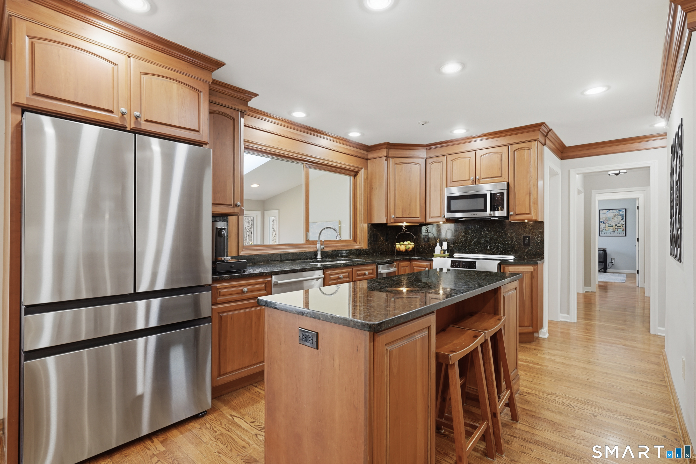 21 Shawnee Lane Monroe, CT 06468 - Photo 13 of 43 a kitchen with stainless steel appliances granite countertop a refrigerator a sink dishwasher a stove and a refrigerator with wooden floor