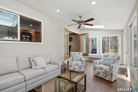 a living room with furniture and wooden floor