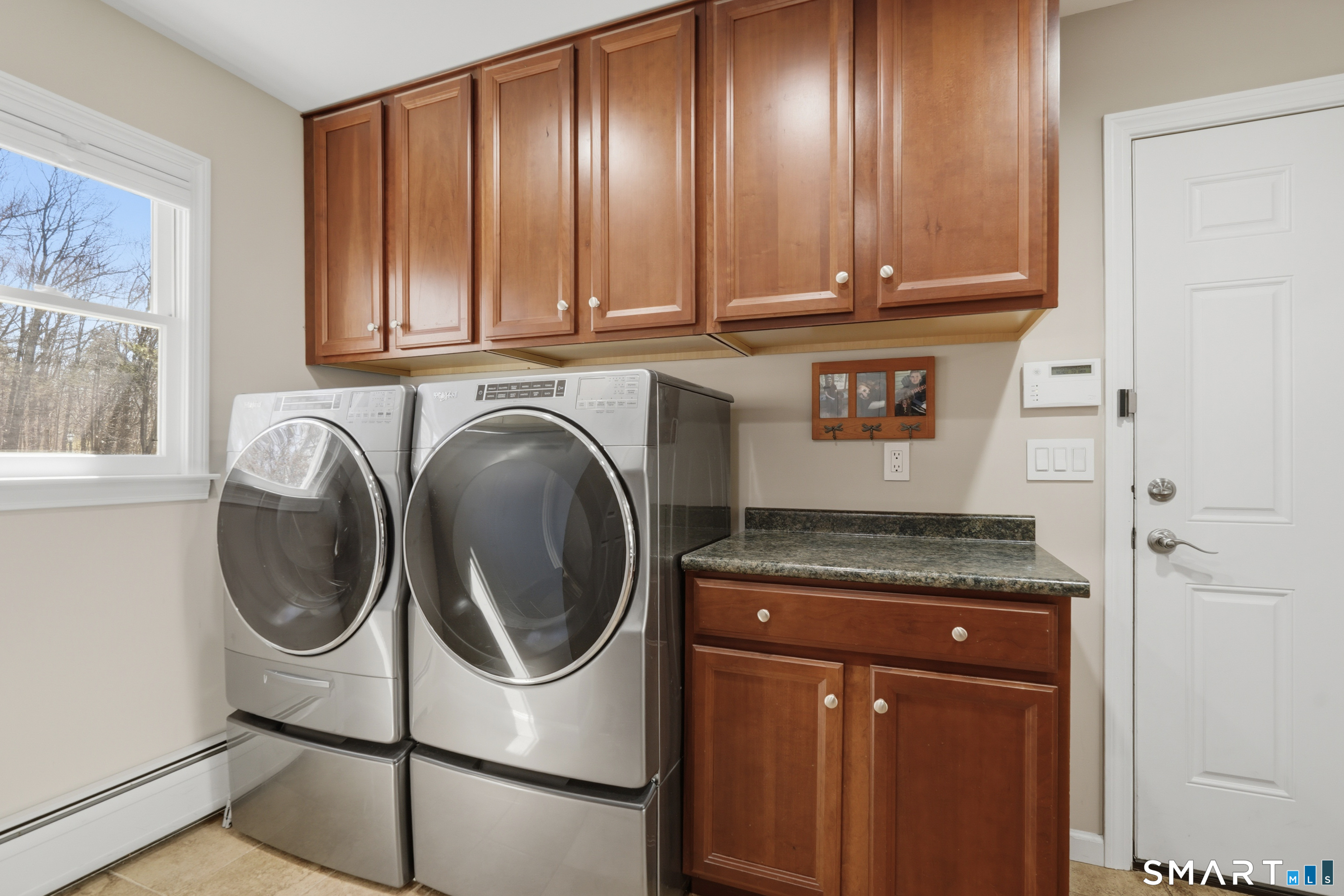 21 Shawnee Lane Monroe, CT 06468 - Photo 24 of 43 a utility room with granite countertop stainless steel appliances wooden floor and cabinets