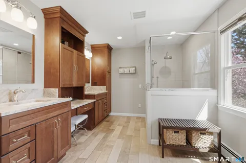 a spacious bathroom with a mirror sink and bathtub