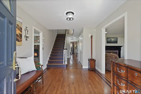 a view of entryway with wooden floor and stairs