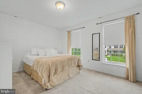 a spacious bedroom with a bed and a window