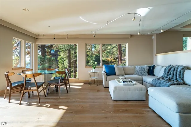a living room with furniture wooden floor and a table